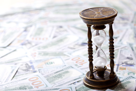 Time is money. Hourglass and us dollars. Money concept