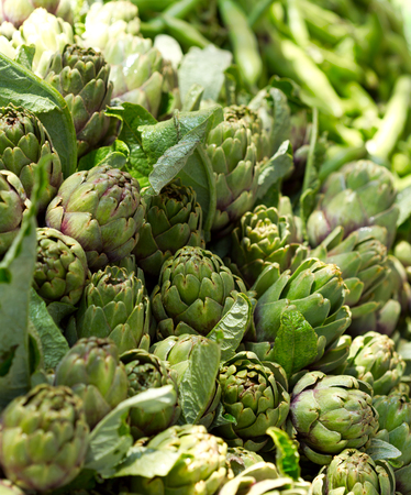 fresh green artichokes in a farmers marketの写真素材