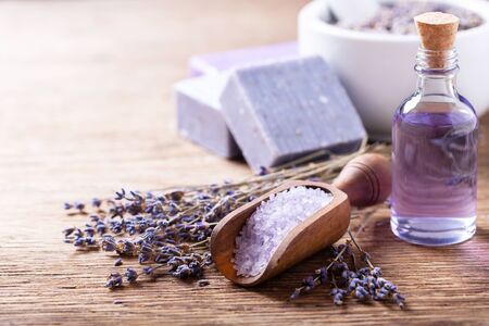 lavender's spa products with dried lavender flowers on a wooden tableの写真素材