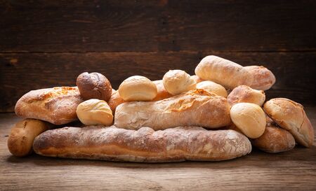 Fresh baked bread  on a rustic wooden tableの写真素材