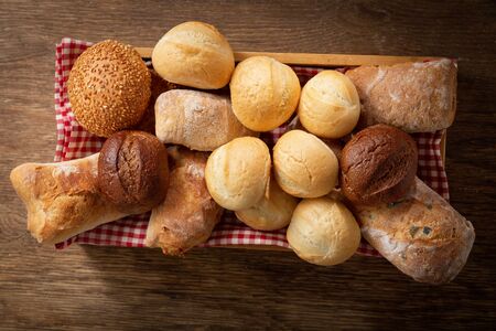 Fresh baked bread on a wooden table, top viewの写真素材