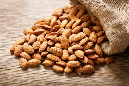 Almond nuts on a wooden tableの写真素材