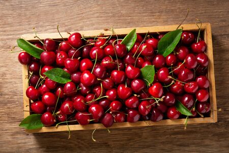 fresh ripe cherries in a wooden box, top viewの写真素材