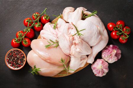 fresh chicken meat with rosemary on a wooden board, top viewの写真素材