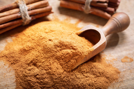 Cinnamon sticks and powder on a wooden table