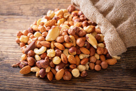 mixed nuts on a wooden table, top viewの写真素材