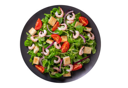 plate of fresh salad with shrimps, greens and tomato isolated on white background, top viewの写真素材