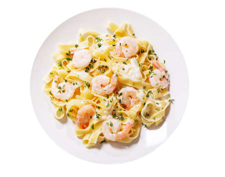 plate of pasta fettuccine with cream sauce and shrimps isolated on a white background, top viewの写真素材