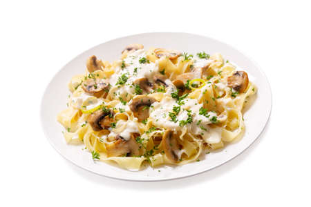 plate of pasta with cream sauce and mushrooms isolated on a white backgroundの写真素材