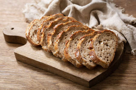 sliced bread on wooden cutting boardの写真素材