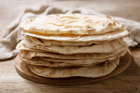 fresh pita bread on a wooden boardの写真素材