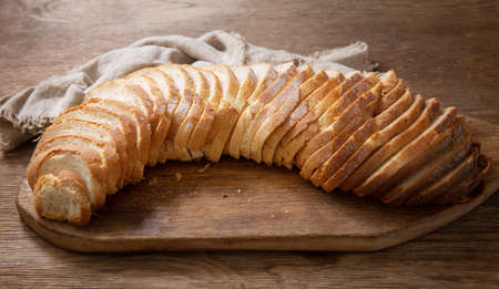 sliced bread on wooden cutting boardの写真素材