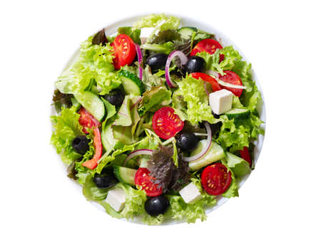 Plate of fresh salad with vegetables, feta cheese and olives isolated on white background, top viewの写真素材