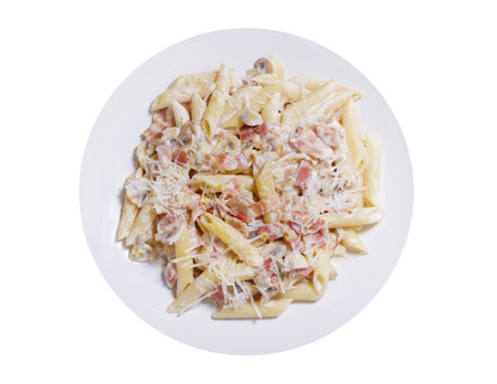 plate of pasta with ham and mushrooms isolated on white background, top viewの写真素材