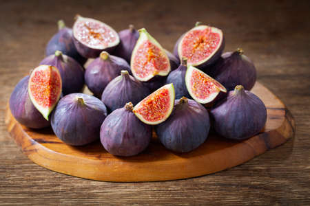 fresh ripe figs fruit on a wooden tableの写真素材