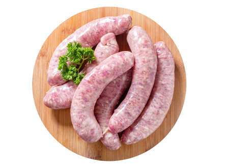 Fresh sausages on a chopping board isolated on white background, top viewの写真素材
