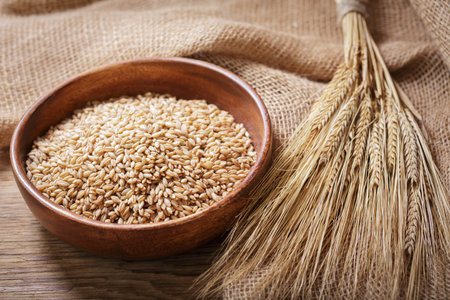 bowl of barley grains on a wooden table
