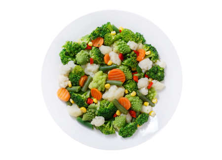 plate of steamed vegetables isolated on a white background, top viewの写真素材