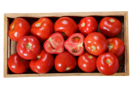 fresh tomatoes in a wooden box isolated on white background, top viewの写真素材