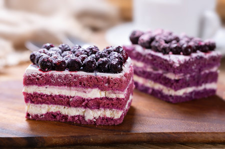 Piece of cake with blueberry on wooden tableの写真素材