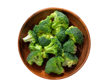 Bowl of fresh broccoli florets isolated on white background, top viewの写真素材