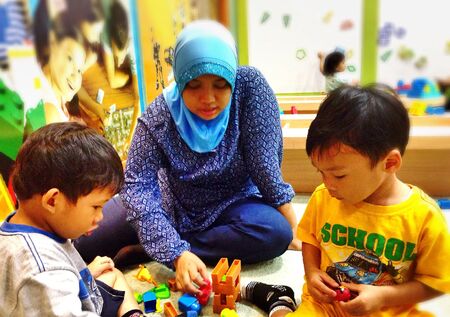 Little boys playing together at playlandの素材