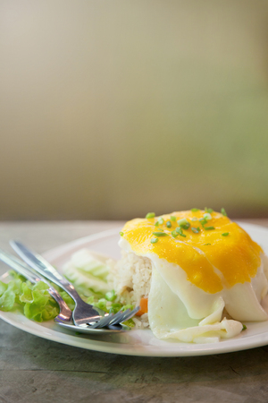 Close up Morning Delicious breakfast fried egg put on fried rice decorate with green vegetables.の写真素材