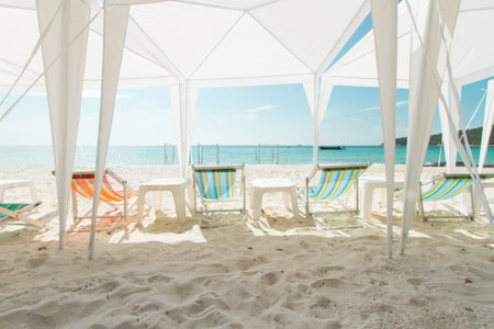 Chairs and white tent at beach, prepare for vacations party.