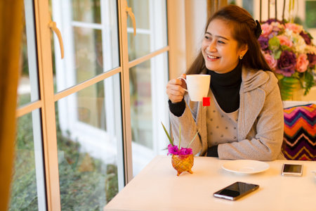 Lifestyle of businesswoman relax with cup of coffee in break time with happy face
