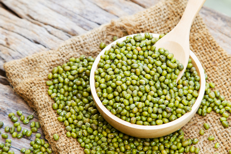Mung bean with wooden spoon on linen fabric sack, rustic and organic farm conceptの写真素材