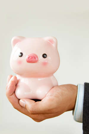 Businessmen holding piggybankの写真素材