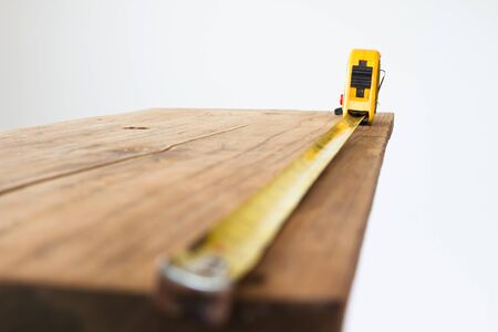 Carpenter tool measuring tape on wood with copy space for background concept.の写真素材