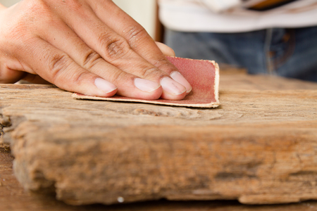 Craftsman Run the sandpaper across the wood surfaceの写真素材