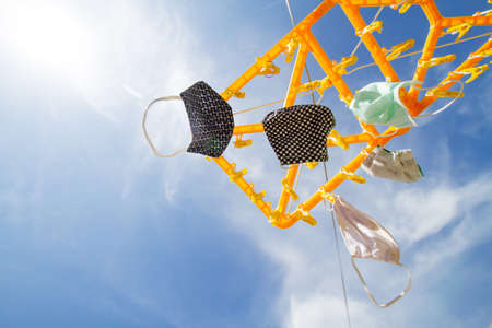 Cleaning a fabric face mask by use a washing machine and powder laundry detergent to kill coronavirus, covid 19 and reuse surgical mask after outdoor activity.の写真素材