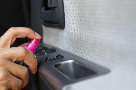 Cleaning Car steering whee with disinfecting wet wipes on surface to kill a coronavirus or touched area.の写真素材
