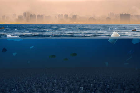 Dirty sea with many garbage bags and plastic product with polluted city on background. Environment damage and Pollution of plastic concept.の写真素材