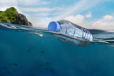 Plastic bottle floating in ocean with aquatic animal, fish. Pollution of plastic and Garbage in open sea concept.の写真素材