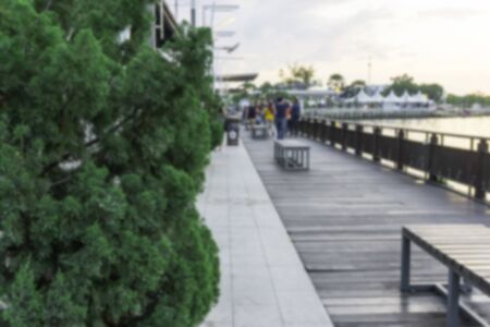 blur public sidewalk river terrace with group of people walking far awayの写真素材