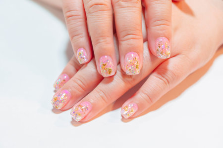 Close up beautiful Trendy crack shell decorated on woman short fingernail with sparkling silver and...