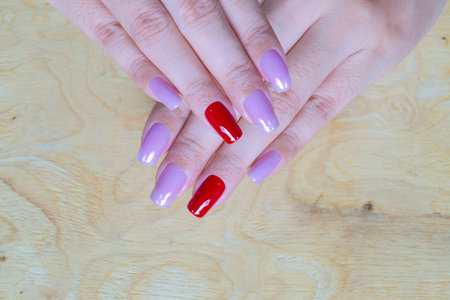 sweet shiny baby violet and dark red colr gel polish painting on long square shape woman fingernail
