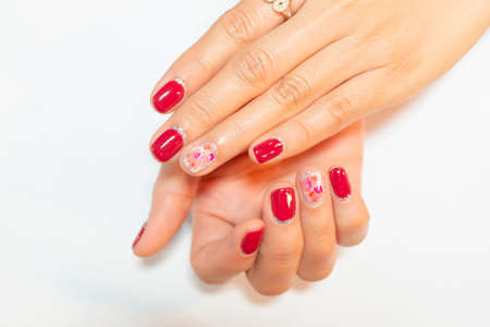 Cute crack shell decorated on woman ring finger with dark pink polish painting shiny silver glitterの写真素材