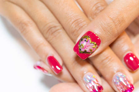 selective fogus of Woman thrumbnail painting dark pink gel polish decorated with sweet pink marble heart with copy spaceの写真素材