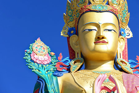 Closeup face of giant Maitreya Buddha statue with blue sky with space in Nubra Valley, Ladakh, Northern India.の写真素材