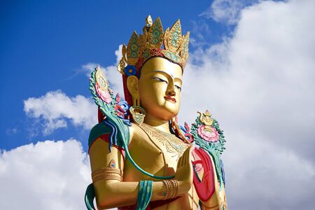 Closeup giant Maitreya Buddha statue with blue sky with clouds in Nubra Valley, Ladakh, Northern India.の写真素材