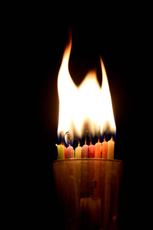 Burning candle on a black background. Shallow depth of field.の写真素材