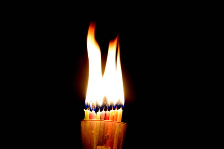 Burning candle on a black background. Close-up image.の写真素材
