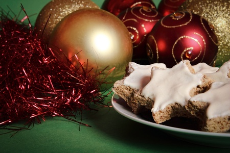 Christmas decorations with traditional cinnamon cookies, on green background.の写真素材
