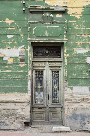 Old dilapidated green door