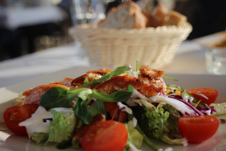 excellent chicken salad in a restaurantの写真素材