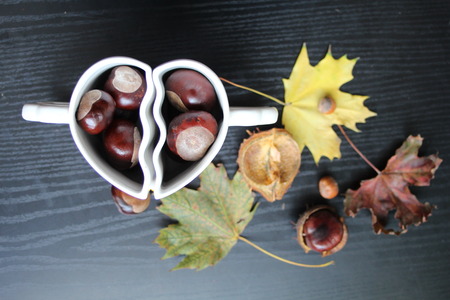 cups in the shape of a heart with autumn fruitsの写真素材
